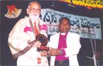 Rev. Dr Acharya R. R. K. Murthy receiving Spl. Seva Ratna Award from Bishop Dr. Chintha David Jhon, click here to see large picture.