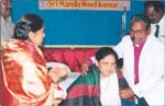 Dr Prabhavathi receiving Seva Ratna from Bishop Dr. Chintha David Jhon, click here to see large picture.